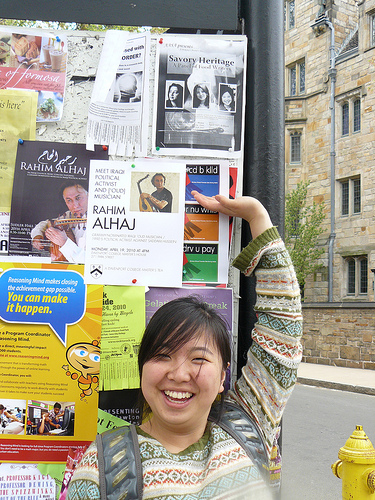 Eunju standing below the event flier