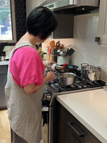 Andrea Nguyen cooking in kitchen